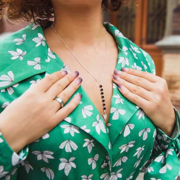 A Woman Wearing 7 Chakra Aromatherapy Diffuser Necklace